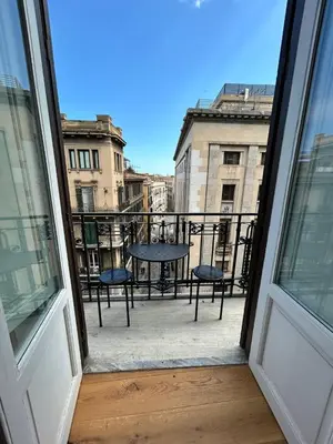 a bathroom with a toilet and a glass shower at Marlè apartment in Palermo