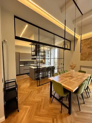 a dining room with a table and chairs and a couch at Marlè apartment in Palermo