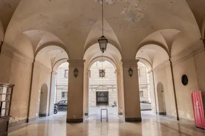 an empty hallway with arched ceilings and a chandelier at Little House Mavi by DomuSicily in Palermo