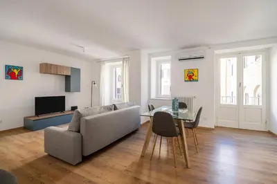 a living room with a couch and a table at Little House Mavi by DomuSicily in Palermo