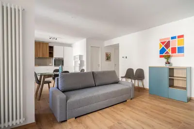 a living room with a couch and a table at Little House Mavi by DomuSicily in Palermo