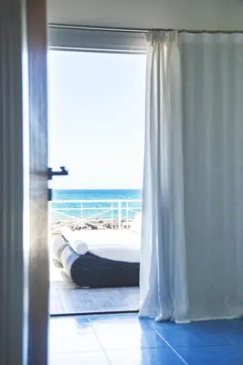 a room with a bed and a view of the ocean at Villa sulla spiaggia Riva Estate by Le Dhome Sicily in Trappeto