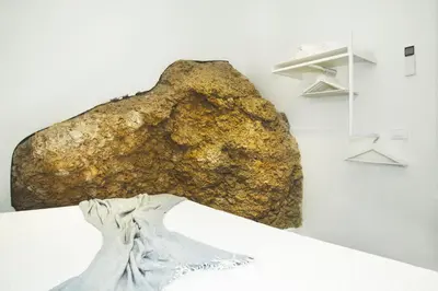 a large rock on the wall in a room at Villa sulla spiaggia Riva Estate by Le Dhome Sicily in Trappeto