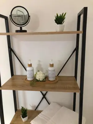 a shelf with two candles and flowers on it at Le Antiche Alcove in Terrasini