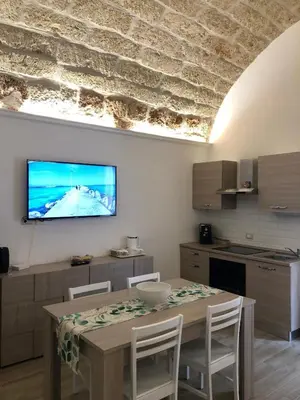 a living room with a couch and a table at Le Antiche Alcove in Terrasini