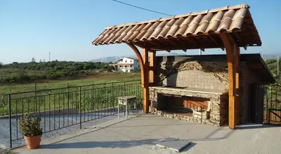 a wooden pavilion with a pizza oven on a patio at Case Vacanza Longo in Balestrate