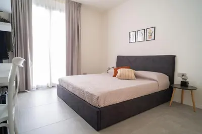 a bedroom with a bed in a room at Acquamarina Rooms in Castellammare del Golfo