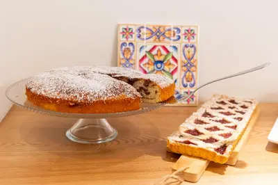 a bundt cake and a piece of bread on a table at Acquamarina Rooms in Castellammare del Golfo