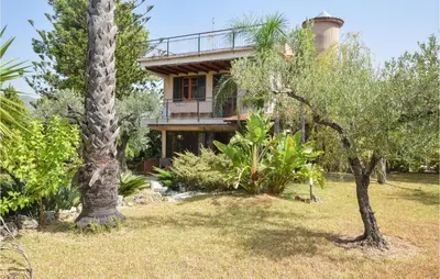a house with a balcony in the middle of trees at 3 Bedroom Lovely Home In Borgetto in Borgetto