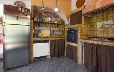 a kitchen with a stainless steel refrigerator and counters at 3 Bedroom Lovely Home In Borgetto in Borgetto