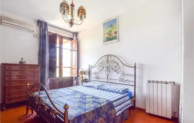 a bedroom with a bed and a dresser and a window at 3 Bedroom Lovely Home In Borgetto in Borgetto