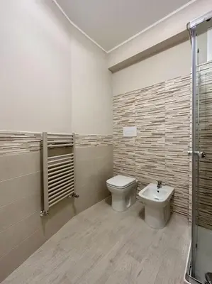 a bathroom with a toilet and a sink at The White Lodge in Porticello