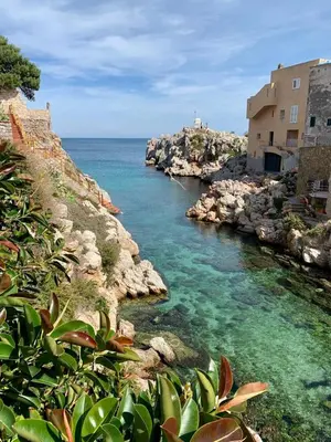 a body of water with rocks and the ocean at The White Lodge in Porticello