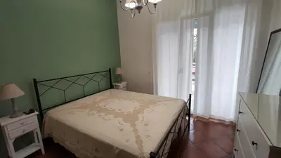 a bedroom with a bed and a dresser and a window at Villa Calici in Pioppo