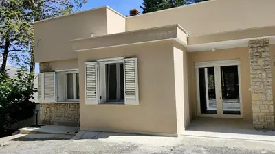 a house with white shutters on the windows at Villa Calici in Pioppo