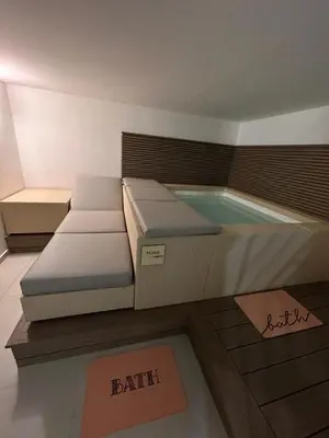 a spa room with a bed and a bathtub at margot palermo in Palermo