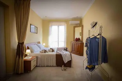 a bedroom with a bed with two dogs on it at Sunshine Apartments in Trappeto
