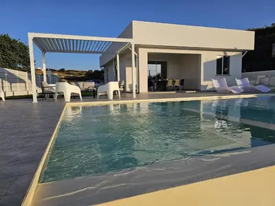 a swimming pool in front of a house at VILLA STELLA LUXURY IN SICILY with swimming pool for exclusive use in Balestrate
