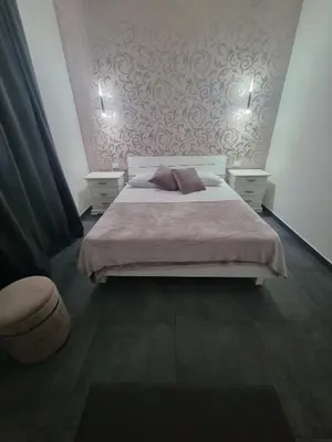 a bedroom with a bed with two night stands and two lamps at VILLA STELLA LUXURY IN SICILY with swimming pool for exclusive use in Balestrate