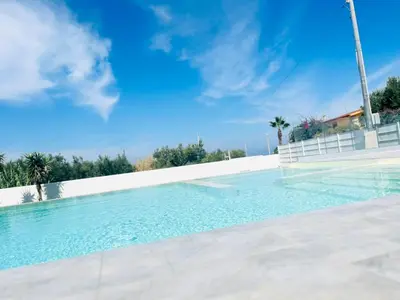 a swimming pool with a blue sky in the background at VILLA STELLA LUXURY IN SICILY with swimming pool for exclusive use in Balestrate