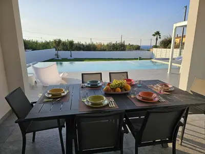 a black table with a bowl of fruit on it at VILLA STELLA LUXURY IN SICILY with swimming pool for exclusive use in Balestrate