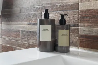 two bottles of soap sitting on top of a sink at CAMA Casa Vacanze - Qui vivi la vera storia normanna in Palermo