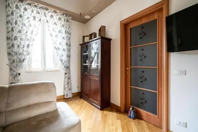 a living room with a cabinet and a window at Plumeria Vacanze in centro a Palermo- Isidoro Carini zona Politeama in Palermo