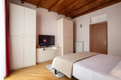 a bedroom with a bed and a flat screen tv at Plumeria Vacanze in centro a Palermo- Isidoro Carini zona Politeama in Palermo