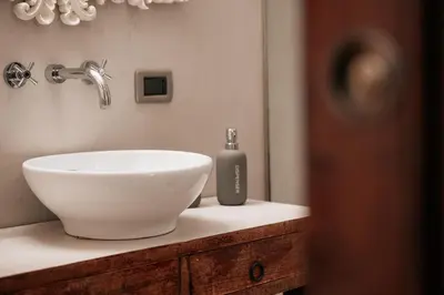 a bathroom sink with a soap dispenser on a counter at Four Luxury Art in Palermo