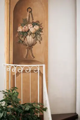 a painting of a vase on a wall next to a staircase at Four Luxury Art in Palermo
