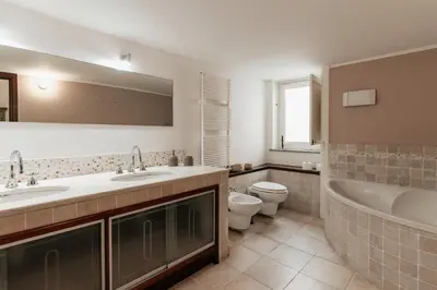 a bathroom with two sinks and a tub and a toilet at Four Luxury Art in Palermo