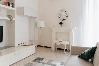 a white living room with a white fireplace and a table at Four Luxury Art in Palermo