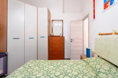 a bedroom with a bed and a dresser at Casa Lo Re in Bagheria