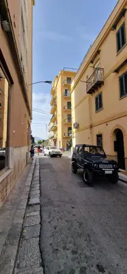 a black jeep parked on the side of a street at Casa Lo Re in Bagheria