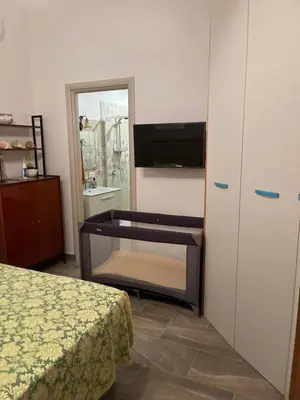 a bedroom with a bed and a dresser and a tv at Casa Lo Re in Bagheria