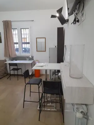 a kitchen with a table and chairs in a room at Makihome in Palermo