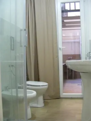 a bathroom with a toilet and a sink and a shower at Makihome in Palermo
