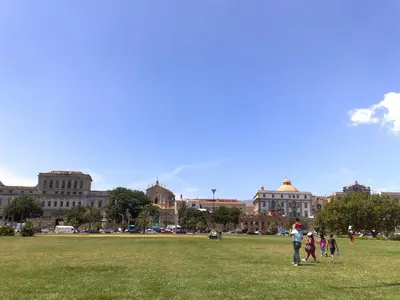 a group of people flying a kite on a field at At Kalsa Quiet Flowered Terrace! Free Parking! Ideal for remote working! in Palermo
