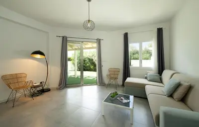 a living room with a couch and a table at Villa Charme in San Vito lo Capo