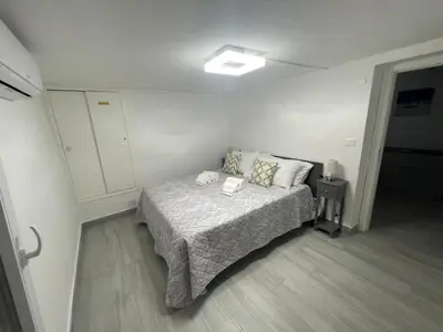 a bedroom with a bed in a white room at Mondello - La casa del vecchio pescatore in Palermo