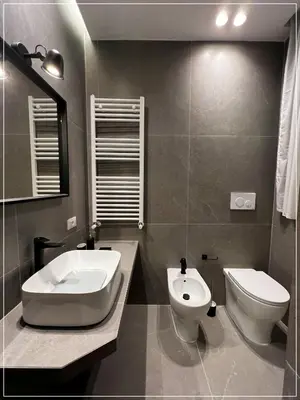 a bathroom with a toilet and a bidet and a sink at ARIOSTO HOME in Palermo