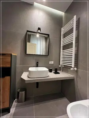 a bathroom with a sink and a mirror at ARIOSTO HOME in Palermo