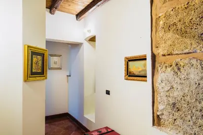 a hallway with paintings on the walls of a building at I Carrettieri - a few steps from the Cathedral in Palermo