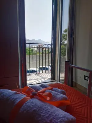 a bedroom with a bed with a bow on it at Casetta Matotta, casa vacanze a Mondello - Palermo in Mondello