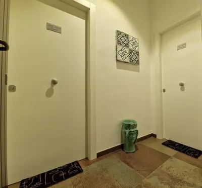 a hallway with two doors and a trash can at Tuttoporto-Apartments LEVANTE in Palermo