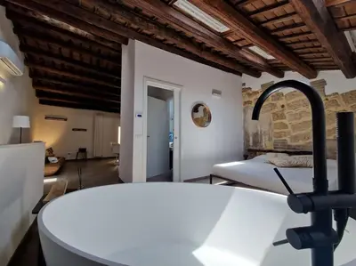 a kitchen with a sink and a bed in a room at Tuttoporto-Apartments LEVANTE in Palermo