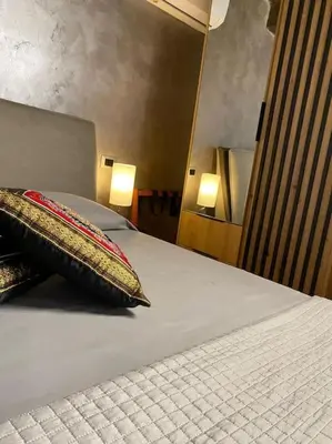 a bed with two pillows sitting on top of it at VeraHouse in Palermo