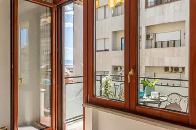 a balcony with a view of a building at La Cassatella family home in Palermo