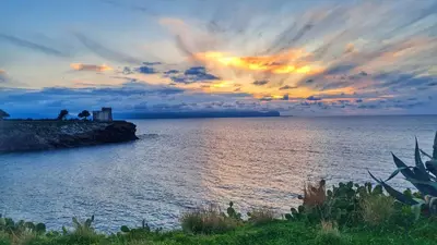 a sunset over a body of water with the sky at NONNO PEPPE Suites 1, 2 & 3 in Terrasini