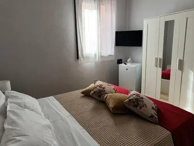a bedroom with a bed with two pillows on it at NONNO PEPPE Suites 1, 2 & 3 in Terrasini